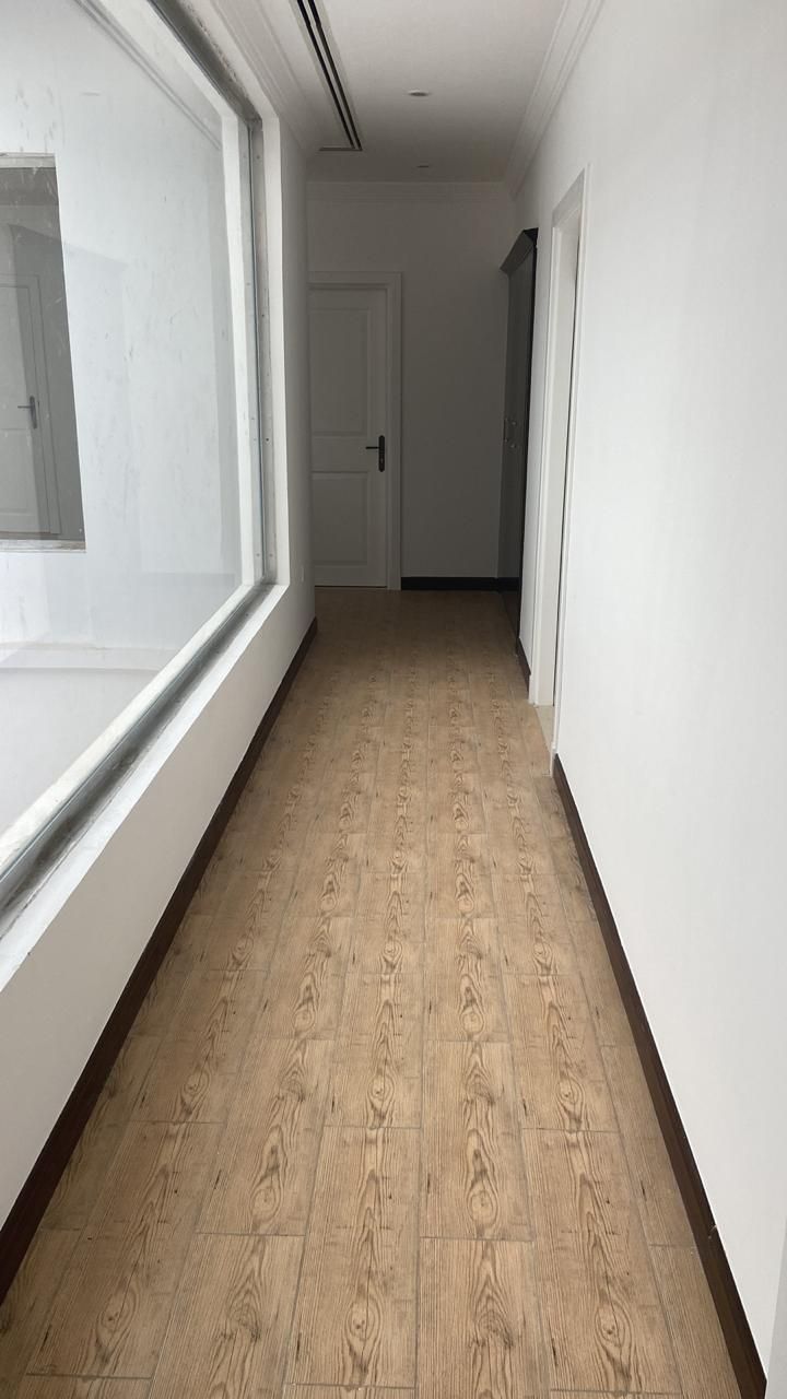 Finished upper corridor with wood-effect flooring and new doors